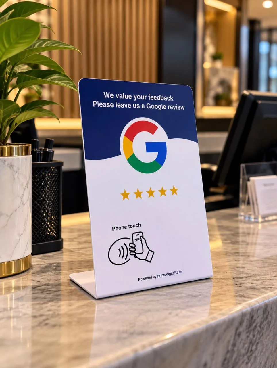 NFC Google review card on its stand beside the till on a marble reception counter.